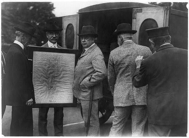 Library of Congress officials transferring page 3 of the United States Constitution from the State Department to the Library of Congress in the Library's Model-T Ford mail wagon