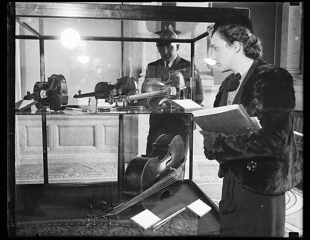 Woman viewing violin display