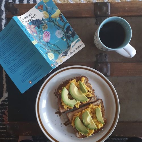 Image of tea, avocado toast, and book Summer Cannibals by Melanie Hobson in Classic Novels as Millennial Clickbait | BookRiot.com