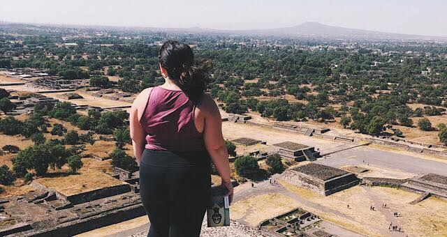 Brunette with a book looking over a view