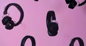 headphones against a pink background
