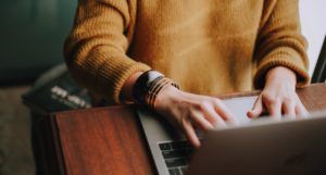 cover image of person typing on a laptop computer