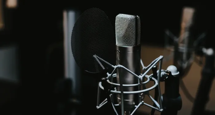a photo of a podcast microphone against a dark background