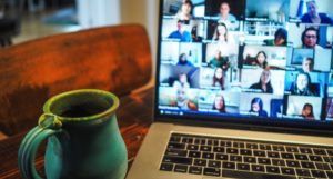 a picture of a laptop screen with a video call with lots of people