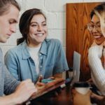 a photo of people talking and laughing together at a table