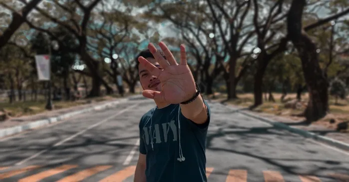 filipino man with hand raised for filipinx feature