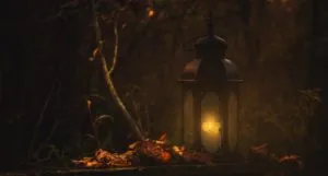 a lantern on a bed of dry leaves in a forest