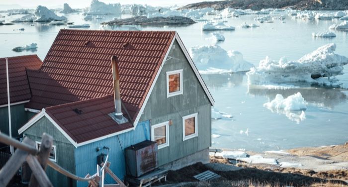 house near icy coast in greenland