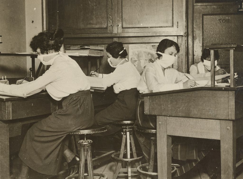 Women clerks in New Your, 1918, wearing face masks. Sourced from the National Archives.