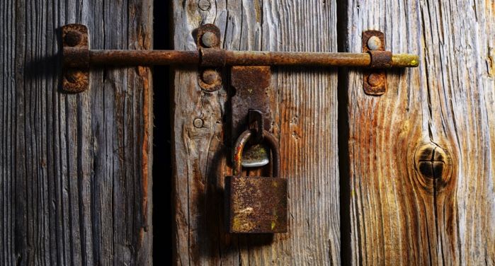 image of a brown padlock on a door