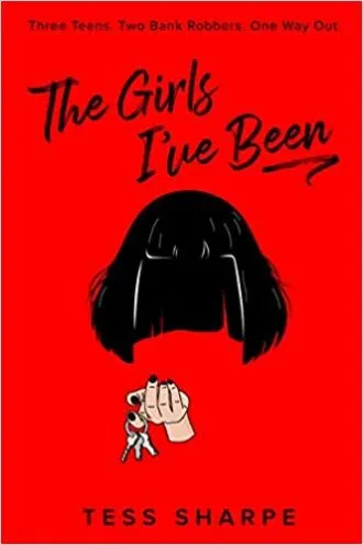cover of The Girls I've Been by Tess Sharpe, showing a Black bobbed wig floating in mid air with a disembodied hand beneath it that's holding a set of keys
