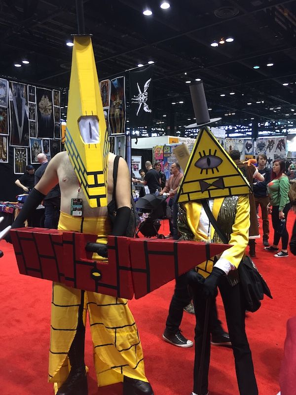 Two Gravity Fall cosplayers with a video game twist. One is Bill and the other is a mashup with Silent Hill's Pyramid Head.