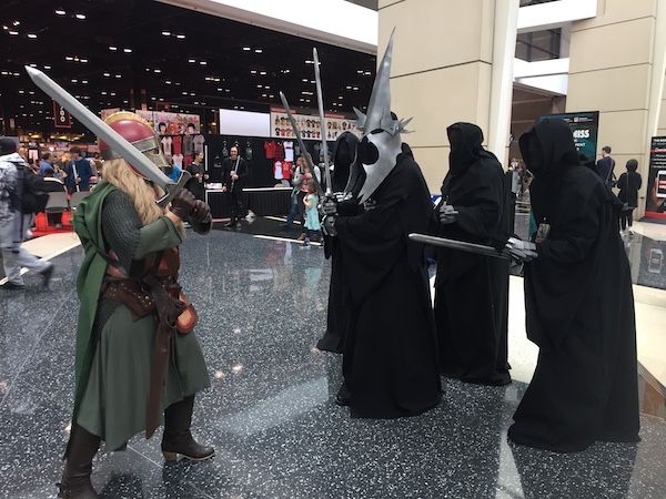 Characters from Lord of the Rings have some fun cosplay. Eowyn in green fights five Nazgul.