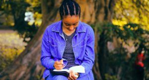 image of a woman at a park reading and writing in a book https://unsplash.com/photos/kSTcz5gE018