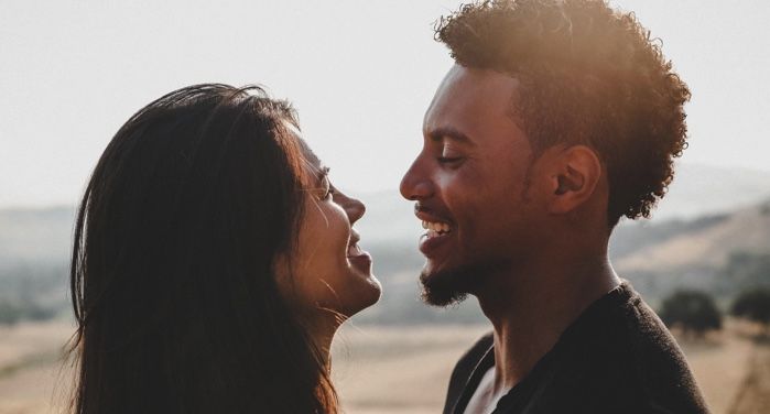 man and woman facing one another and smiling/laughing https://unsplash.com/photos/6rKkr2fh2-I