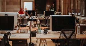 several desktop monitors on wooden desks in an office space https://unsplash.com/photos/wgivdx9dBdQ