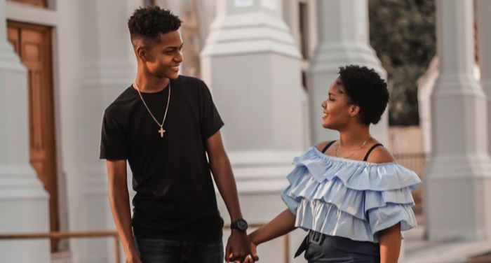 young black couple walking down the street together