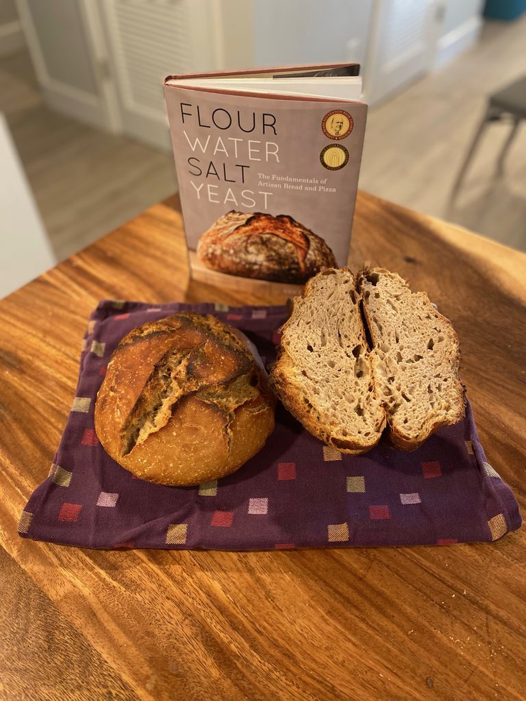 Flour Water Salt Yeast cookbook with two baked loaves