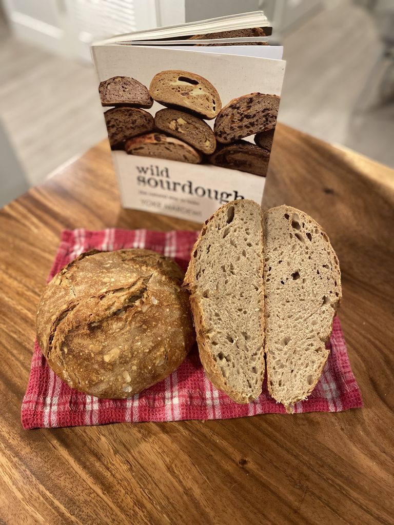 Wild Sourdough cookbook with two baked loaves