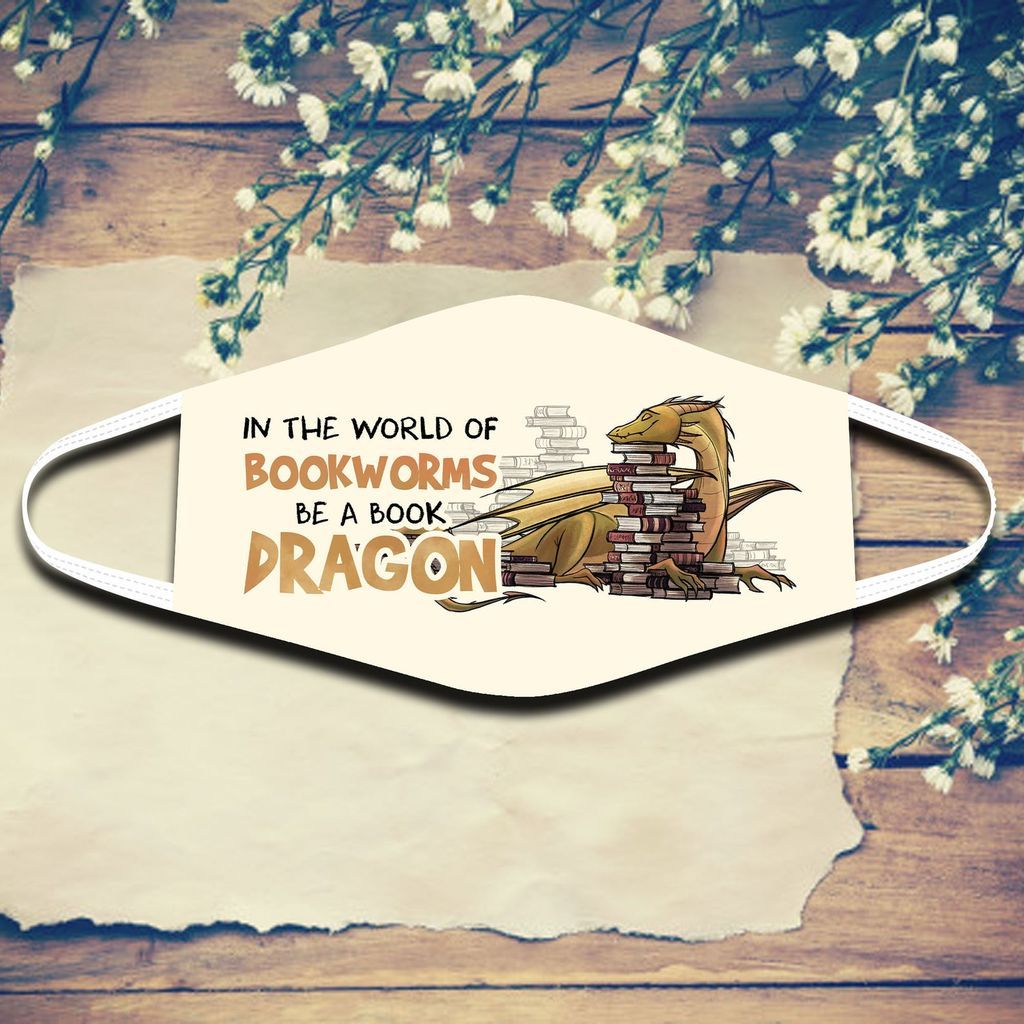 A face mask with a dragon happily resting its head on a stack of books. The text reads "In the world of bookworms, be a book dragon"