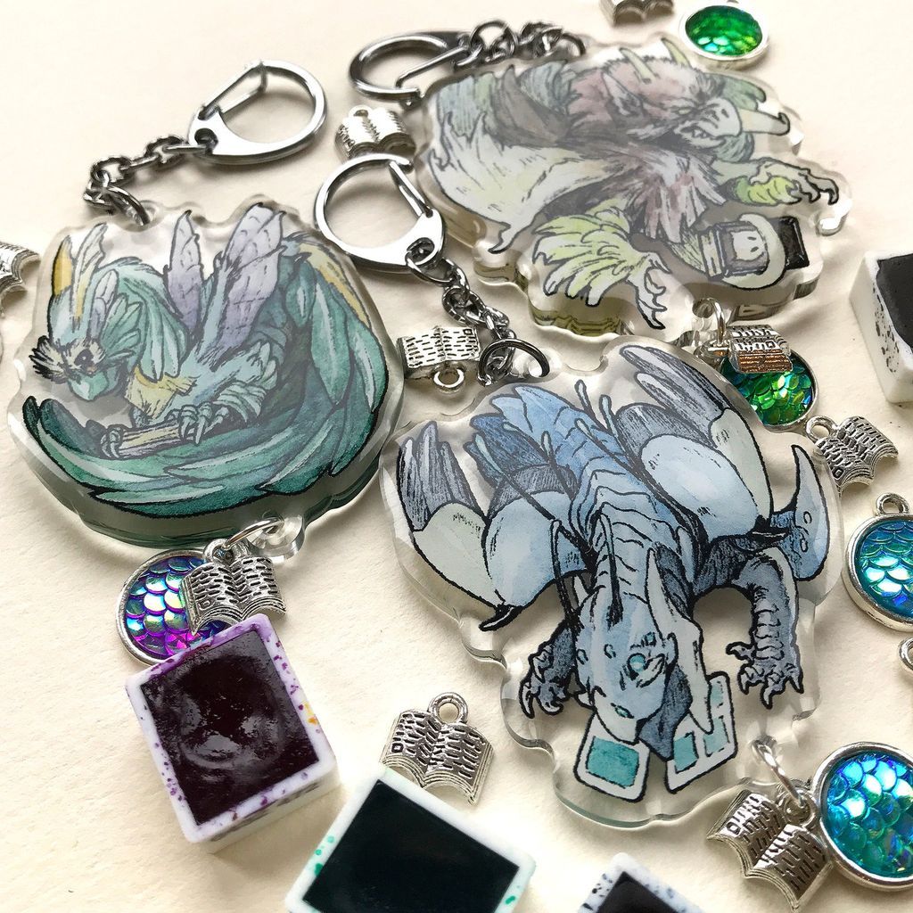 Three acrylic reading dragon charms