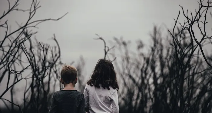 children in a creepy field for horror