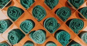 green towels in wooden diamond shaped cubbies