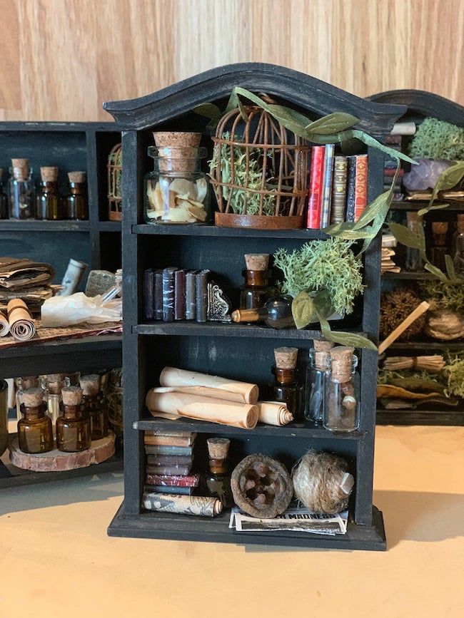 miniature bookcase with scrolls