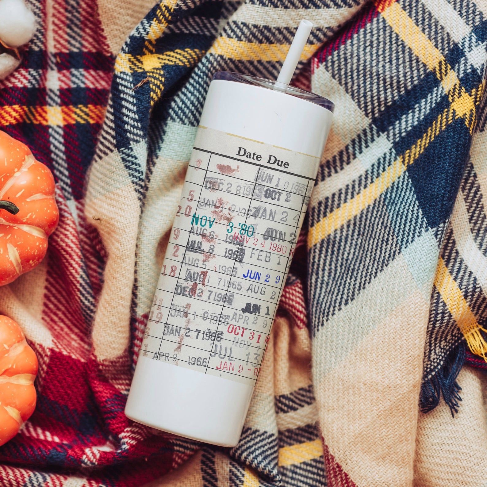 A white water bottle with a library card image in the middle. At the top it reads Due Date, and there are stamped dates underneath like a library card 