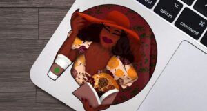 Image of a small sticker depicting a glamorous Black woman in a read hat and yellow floral dress, with a cup of coffee. She's holding a book that is open, and glowing light and fall florals seem to be bursting form the book.