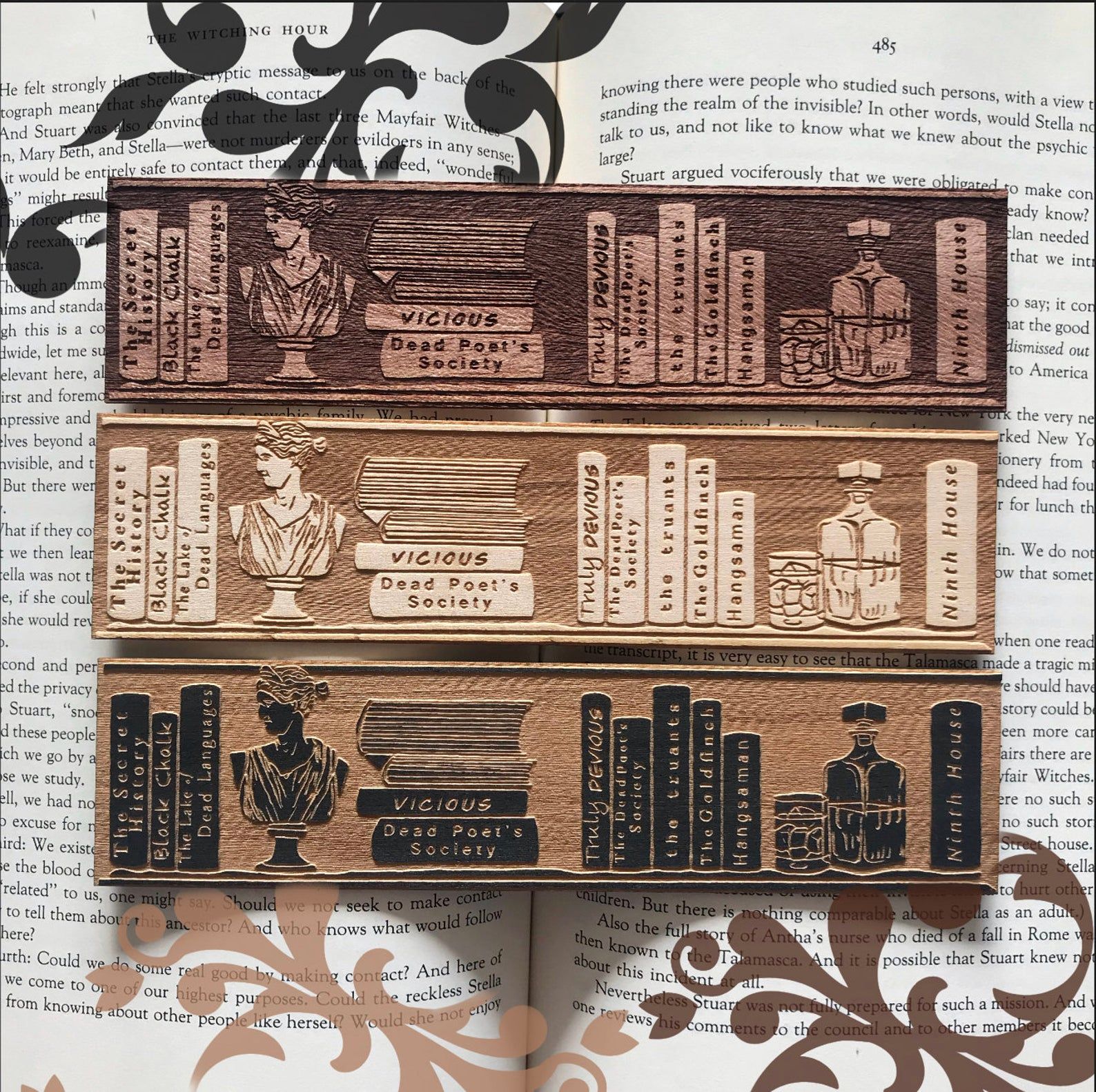 Image of wooden bookmark with bookshelves full of dark academia books. 