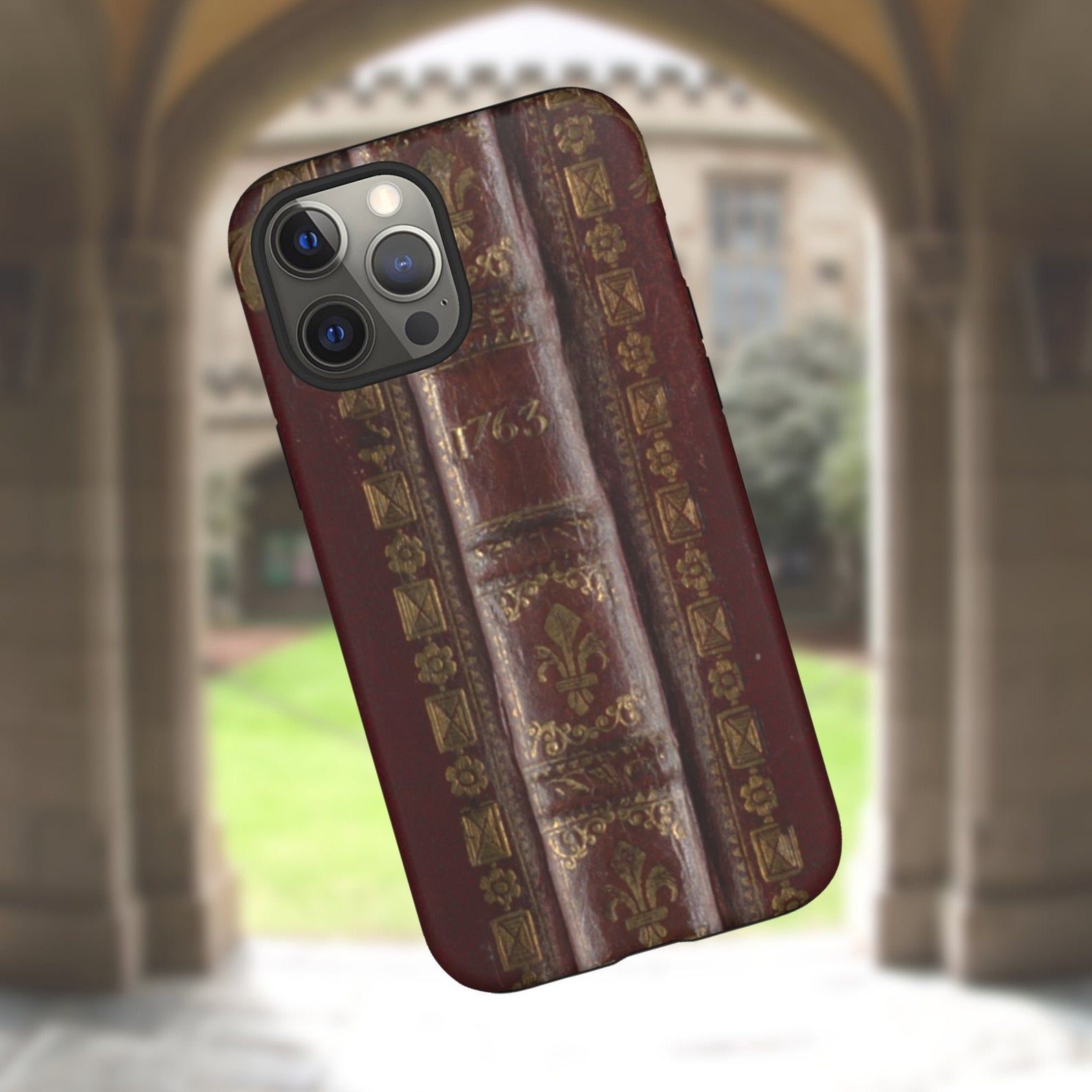 Image of a phone case featuring an old book spine design. 