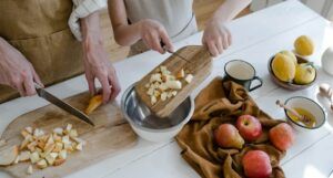 two people making apple pie