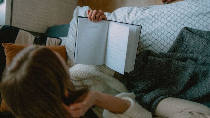 Image of a person holding open a book