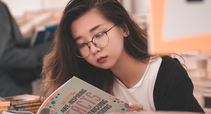 Image of tween reading a book