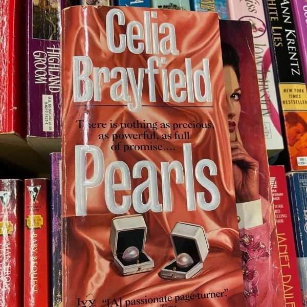 cover of Celia Brayfield's Pearls, with an obvious stepback showing a woman's face peeking out