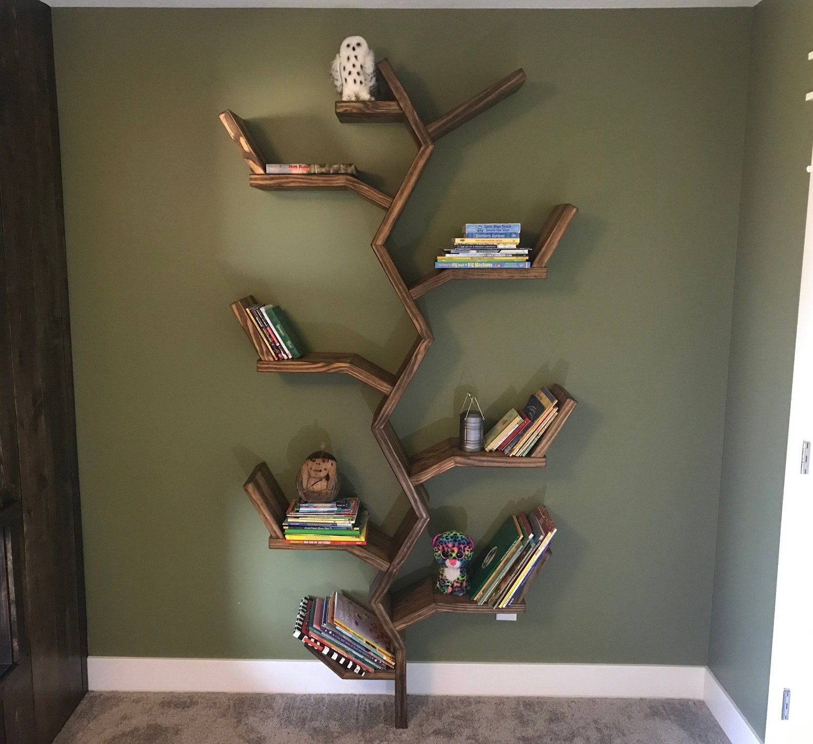 tree-shaped bookcase with books on each branch shelf