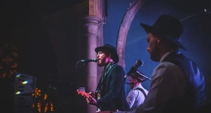 two men in a band playing on stage