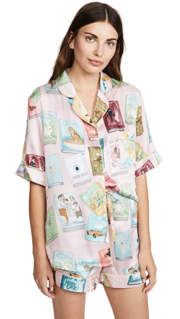 A short pink silk pajamas set with a pattern of classic book covers