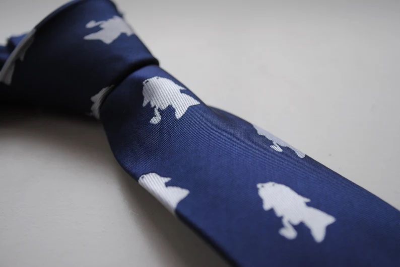 Navy blue tie with white silhouette of man smoking a pipe.