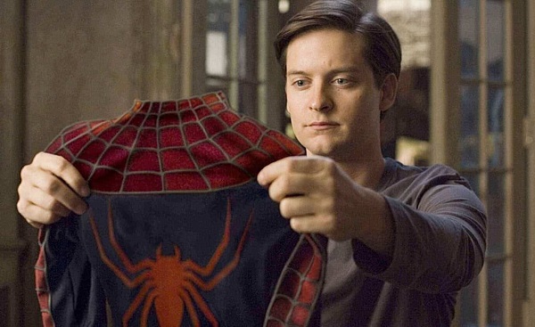 Screenshot of Tobey Maguire as Peter Parker holding the Spider-Man costume in 'Spider-Man' (2002)