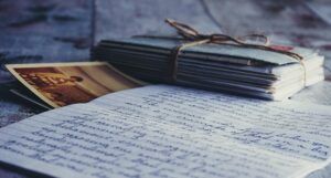 stack of letters tied with string and a photograph