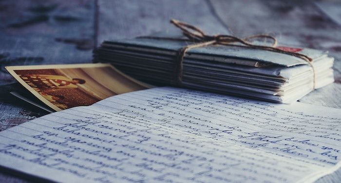 stack of letters tied with string and a photograph