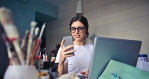 image of woman in white shirt look at phone