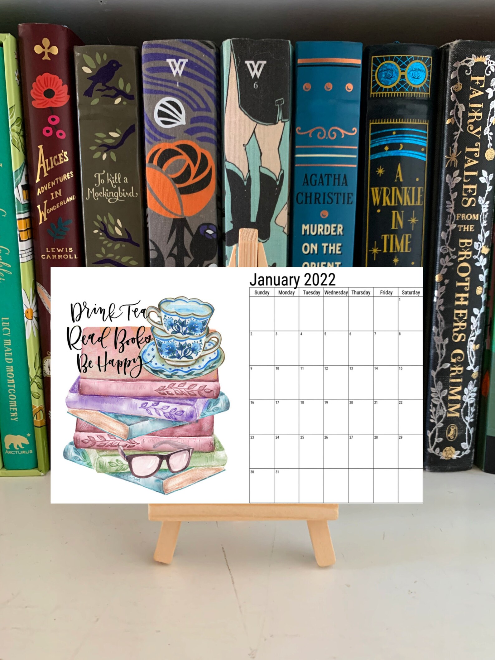 A picture of a small desk calendar featuring bookish quotes, on a small wooden stand.