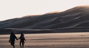 people holding hands in the desert