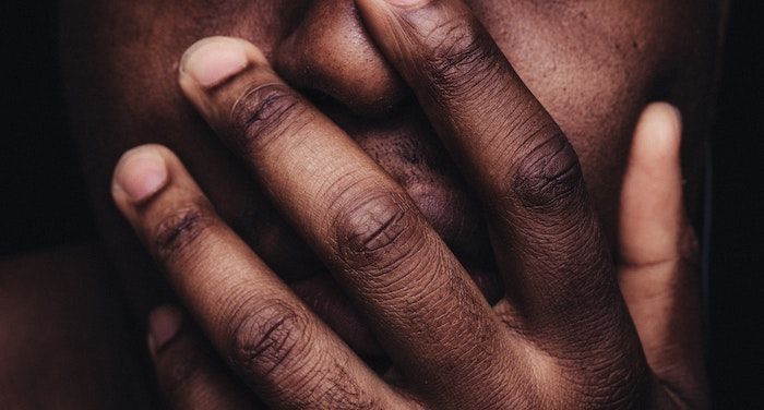 image of a Black hand over a mouth