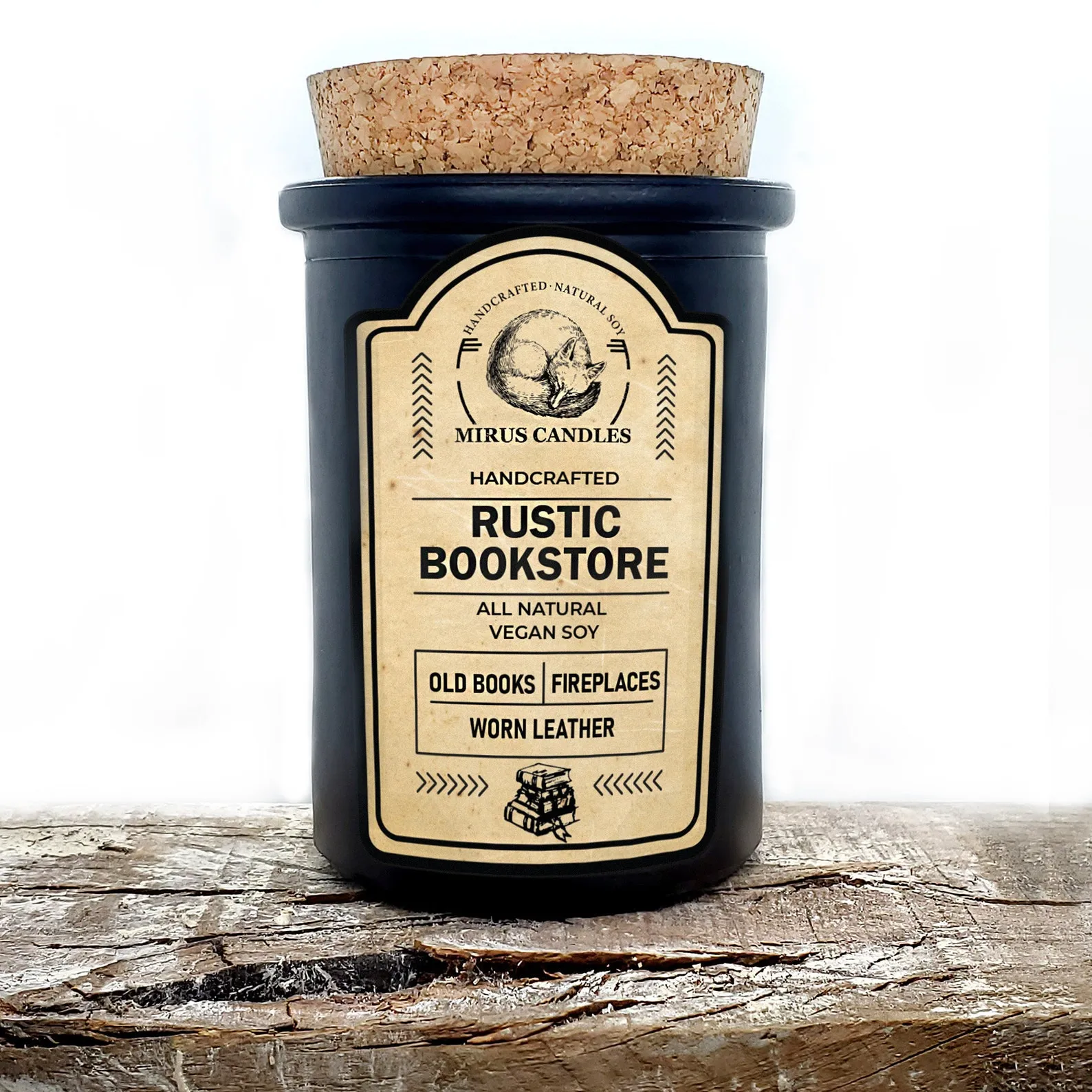 Image of a candle on a piece of wood. The candle is in a dark jar with a cork lid. The label is a vintage style. 