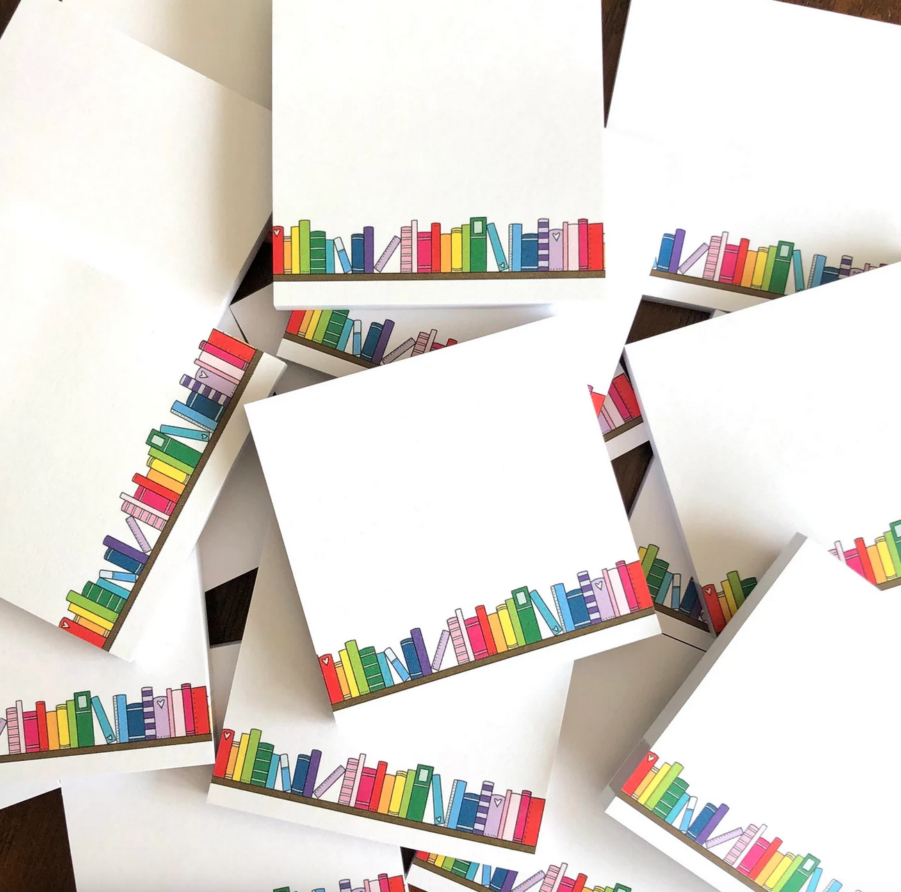 Pile of sticky note pads with colorful book graphics