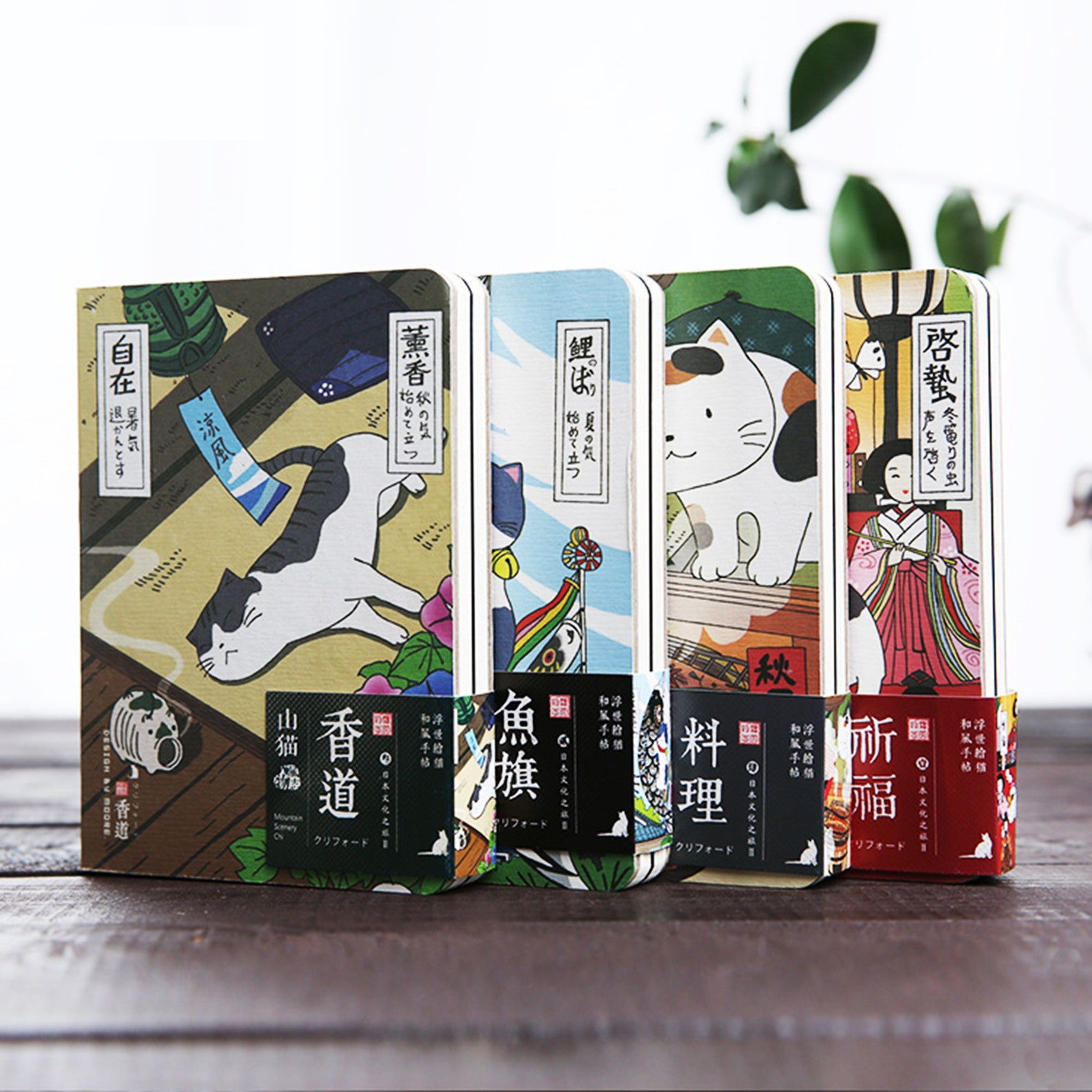 Four notebooks. They are designed in Japanese anime style and all feature cats. 